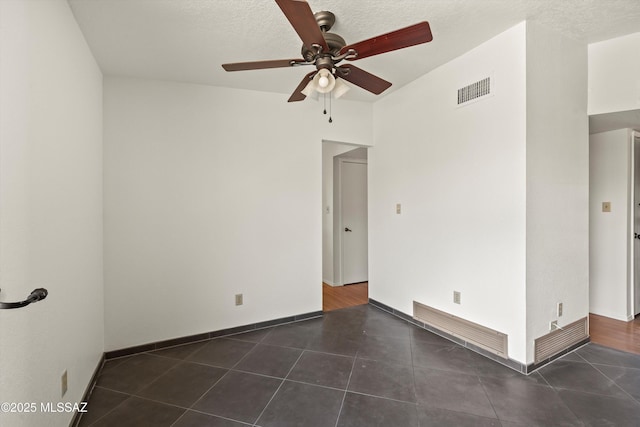 9770 E Hollow Pl, Tucson, AZ 85748 - tiled spare room with a textured ceiling, visible vents, and a ceiling fan