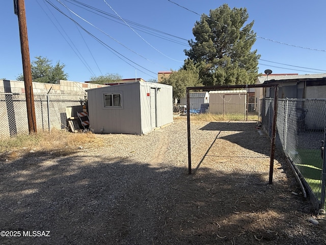 276 E Pastime Rd, Tucson, AZ 85705 - view of yard featuring an outbuilding, a storage unit, and fence