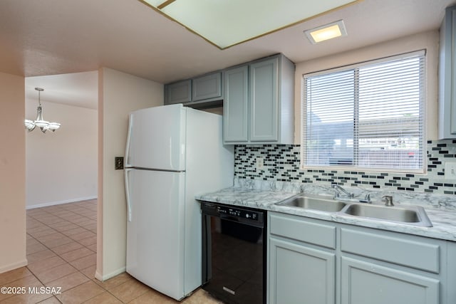 kitchen with dishwasher, backsplash, a sink, and freestanding refrigerator
