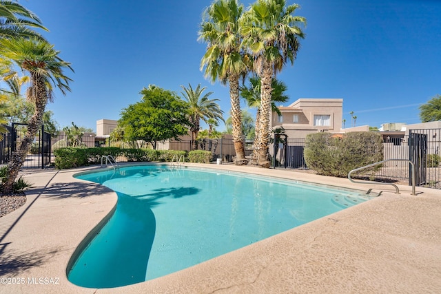 community pool featuring fence and a patio