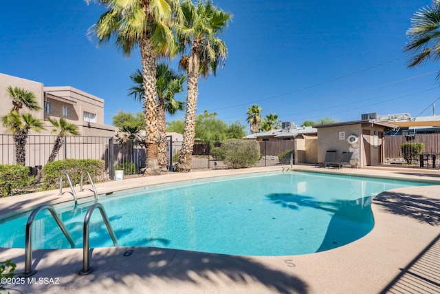 community pool featuring fence and a patio