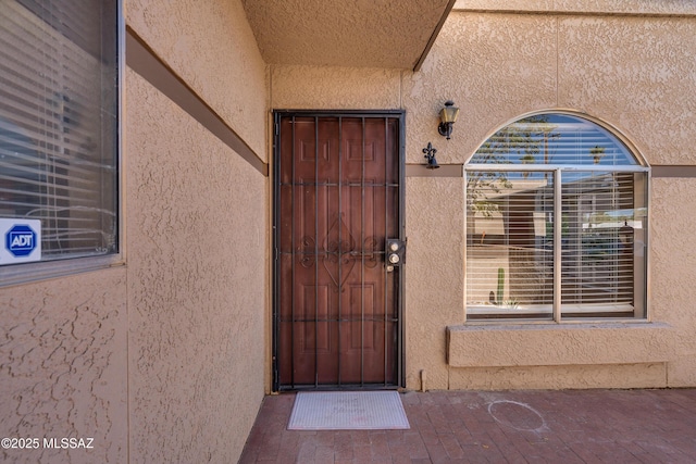 property entrance with stucco siding
