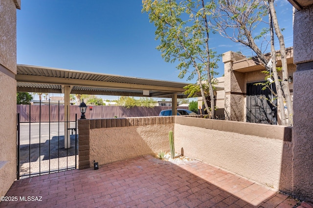 view of patio with a gate and fence