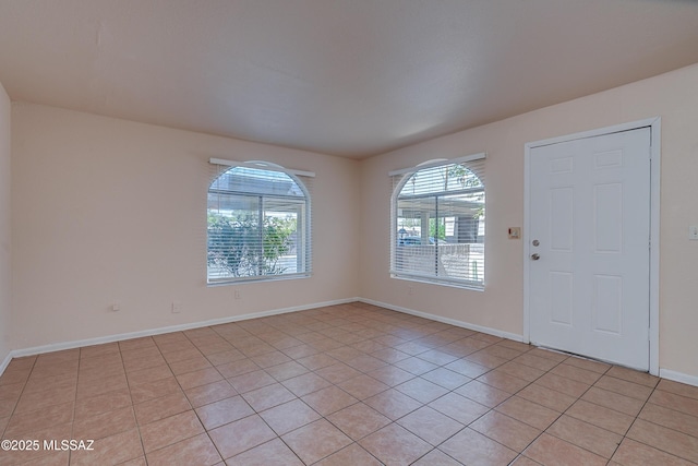 interior space featuring baseboards and light tile patterned floors