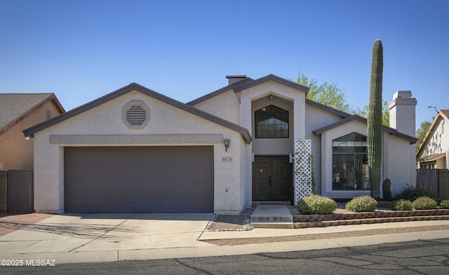 9810 E Amaroso Ln, Tucson, AZ 85748 - view of front of house featuring stucco siding, concrete driveway, and an attached garage
