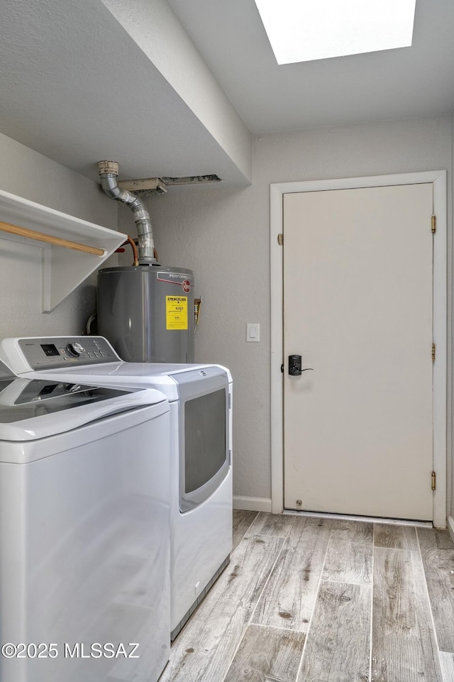 9810 E Amaroso Ln, Tucson, AZ 85748 - washroom featuring a skylight, separate washer and dryer, water heater, light wood-style flooring, and laundry area