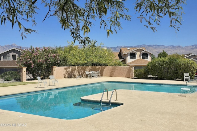 9810 E Amaroso Ln, Tucson, AZ 85748 - view of swimming pool featuring a patio, a mountain view, and fence