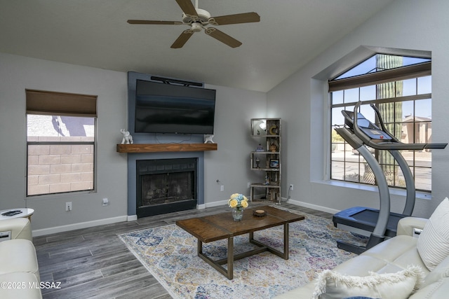 9810 E Amaroso Ln, Tucson, AZ 85748 - living area with a fireplace, ceiling fan, a healthy amount of sunlight, vaulted ceiling, and wood finished floors