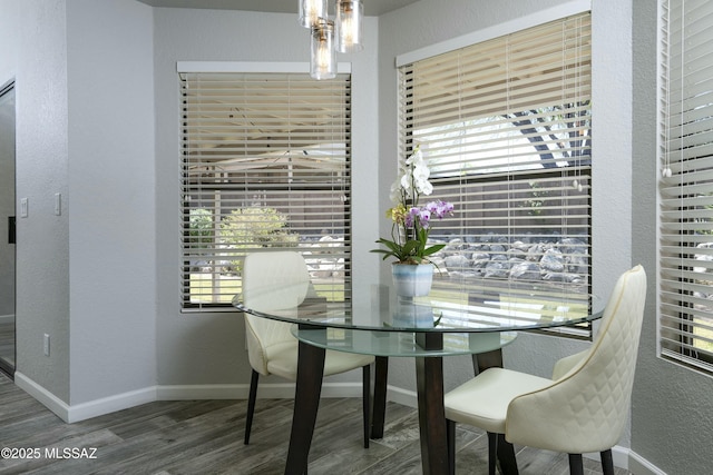 9810 E Amaroso Ln, Tucson, AZ 85748 - dining area featuring a healthy amount of sunlight, a textured wall, wood finished floors, and baseboards