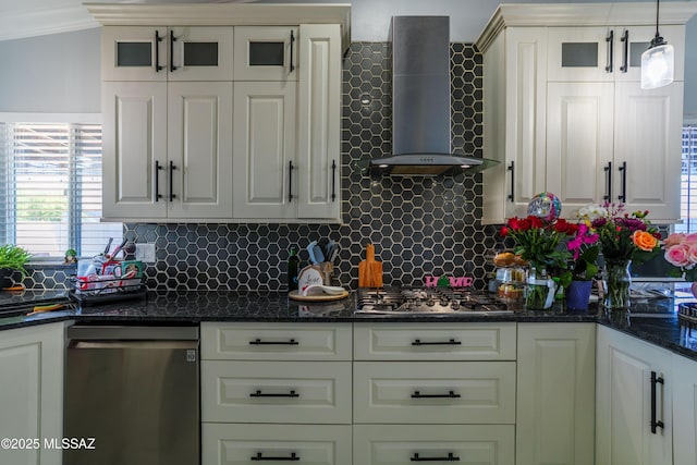 kitchen featuring wall chimney range hood, a wealth of natural light, decorative backsplash, and appliances with stainless steel finishes