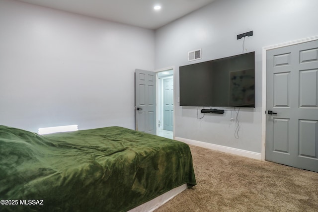 bedroom featuring a towering ceiling, visible vents, carpet, and baseboards