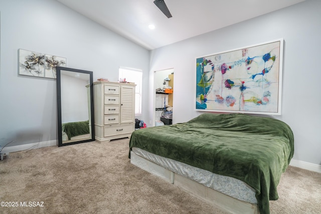 carpeted bedroom featuring a ceiling fan, high vaulted ceiling, a spacious closet, and baseboards