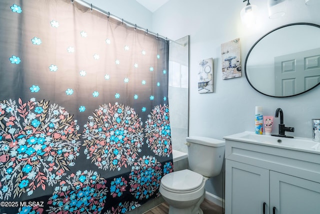 bathroom with shower / bath combo, wood finished floors, toilet, and vanity