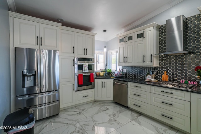 kitchen featuring stainless steel appliances, tasteful backsplash, wall chimney exhaust hood, ornamental molding, and dark countertops