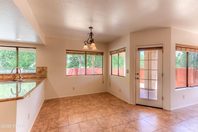 5476 N Indian Trl, Tucson, AZ 85750 - interior space with an inviting chandelier, baseboards, a sink, and light tile patterned floors