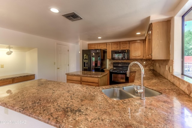 5476 N Indian Trl, Tucson, AZ 85750 - kitchen featuring light stone counters, a sink, black appliances, backsplash, and visible vents