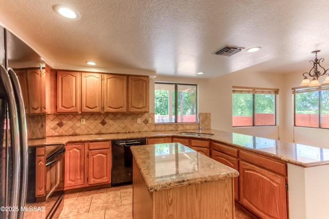 5476 N Indian Trl, Tucson, AZ 85750 - kitchen with visible vents, a center island, decorative backsplash, black appliances, and a peninsula