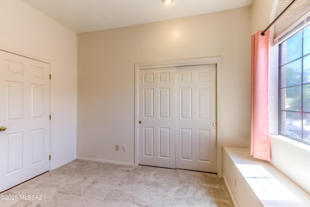 5476 N Indian Trl, Tucson, AZ 85750 - unfurnished bedroom featuring baseboards, carpet floors, and a closet