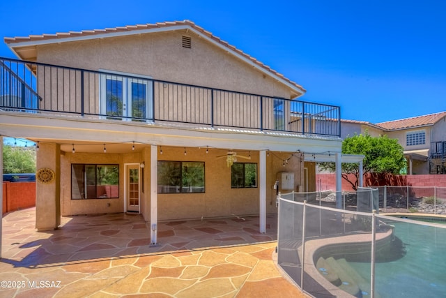 5476 N Indian Trl, Tucson, AZ 85750 - back of property with a ceiling fan, fence, a balcony, stucco siding, and a patio area