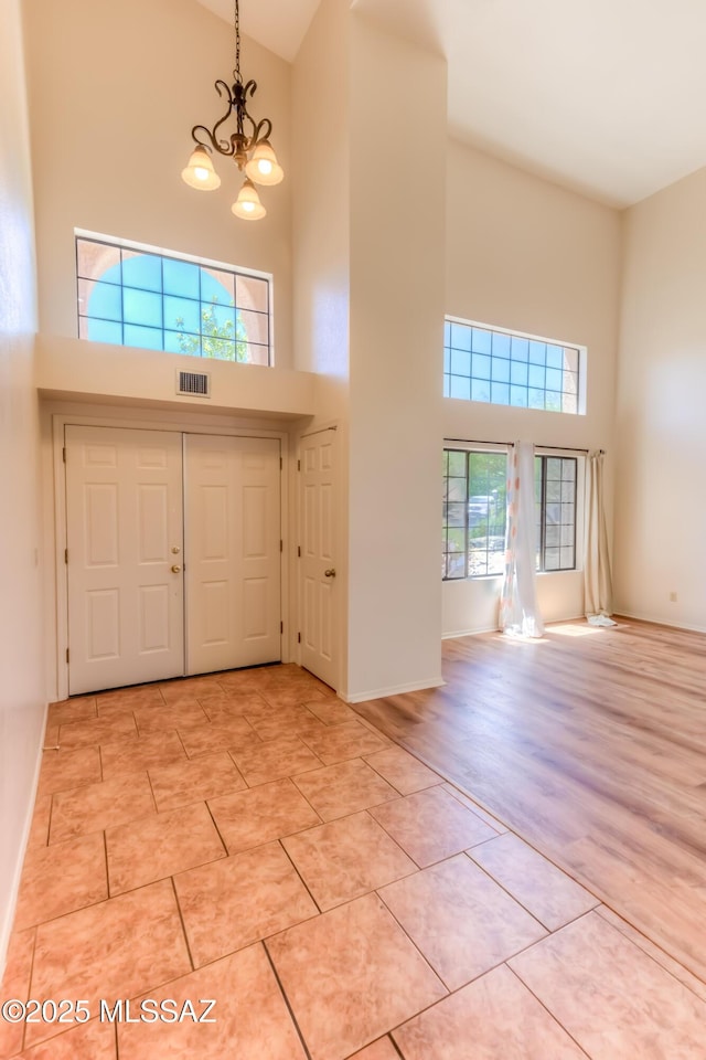 5476 N Indian Trl, Tucson, AZ 85750 - foyer entrance featuring a high ceiling, a chandelier, visible vents, and light tile patterned floors