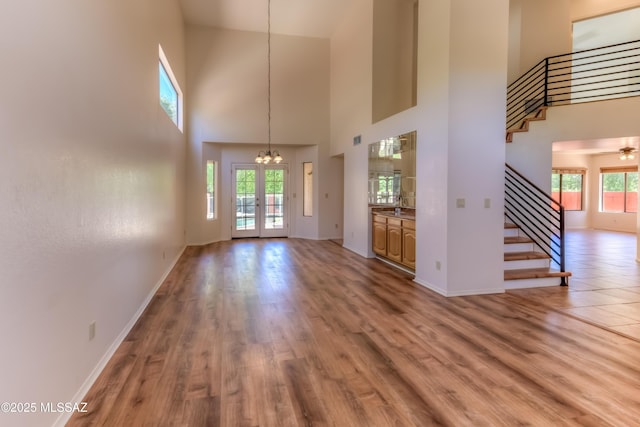 5476 N Indian Trl, Tucson, AZ 85750 - interior space with baseboards, a high ceiling, an inviting chandelier, and stairs