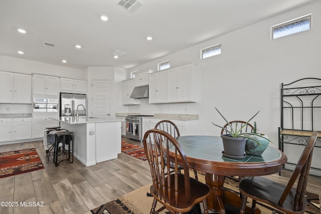 dining area featuring recessed lighting, visible vents, and light wood-style flooring
