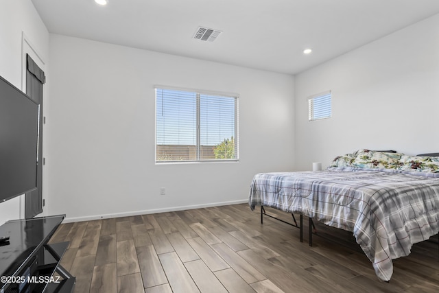 bedroom with recessed lighting, visible vents, wood finished floors, and baseboards