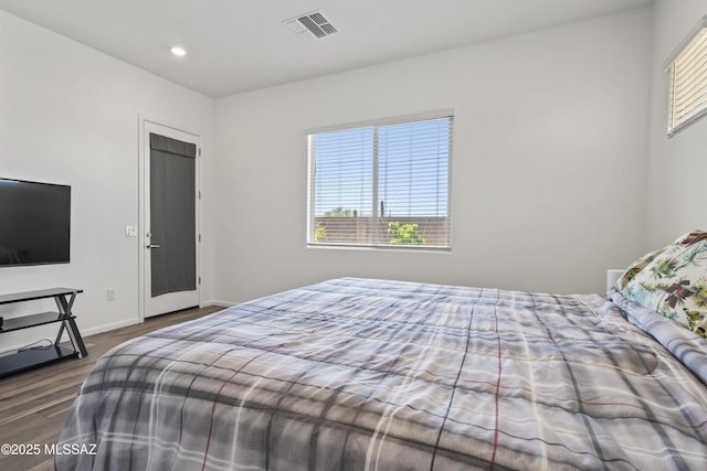 bedroom featuring recessed lighting, visible vents, wood finished floors, and baseboards