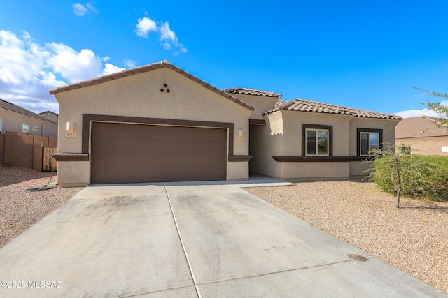 491 W Camino Del Toro, Vail, AZ 85641 - mediterranean / spanish home featuring an attached garage, concrete driveway, stucco siding, and a tiled roof