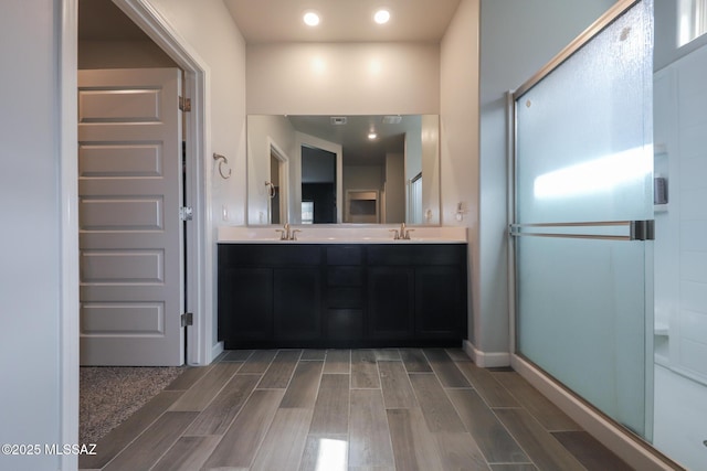 491 W Camino Del Toro, Vail, AZ 85641 - bathroom with wood finish floors, double vanity, a shower stall, recessed lighting, and baseboards