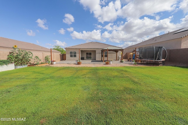 491 W Camino Del Toro, Vail, AZ 85641 - back of house with a trampoline, a patio area, stucco siding, and a tile roof