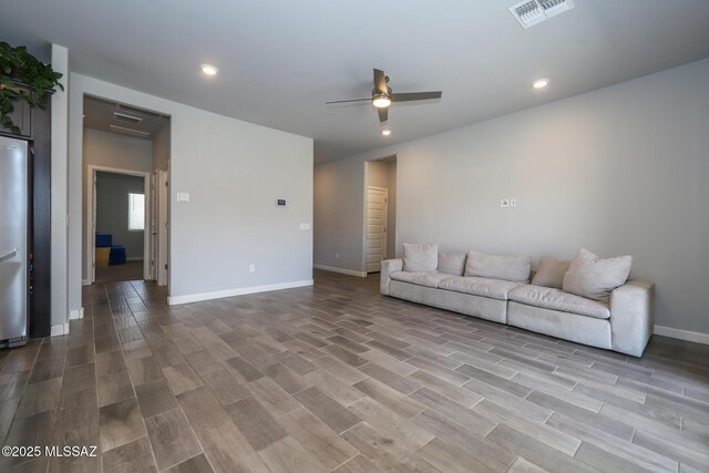 491 W Camino Del Toro, Vail, AZ 85641 - unfurnished living room with ceiling fan, wood finished floors, recessed lighting, and baseboards
