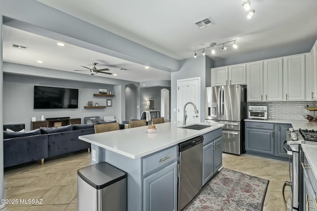 10658 E Rose Hill St, Tucson, AZ 85747 - kitchen with stainless steel appliances, arched walkways, visible vents, and a sink