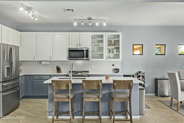 10658 E Rose Hill St, Tucson, AZ 85747 - kitchen featuring stainless steel appliances, backsplash, light countertops, visible vents, and gray cabinetry