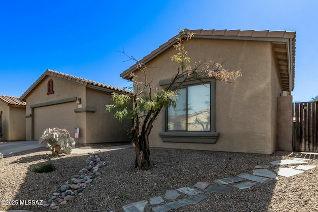 10658 E Rose Hill St, Tucson, AZ 85747 - view of front of home with stucco siding and a garage