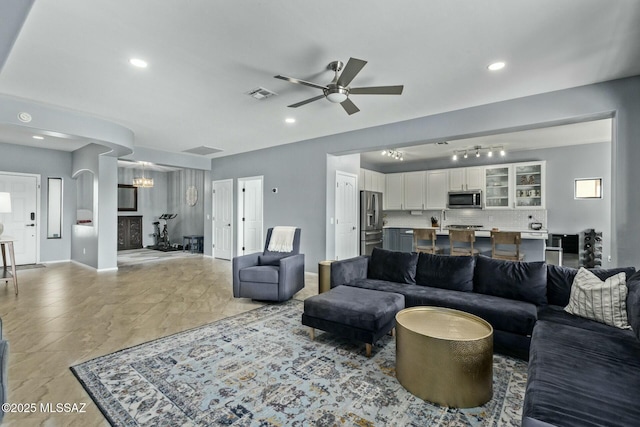10658 E Rose Hill St, Tucson, AZ 85747 - living area featuring recessed lighting, baseboards, visible vents, and ceiling fan with notable chandelier
