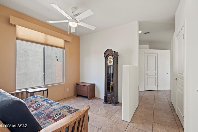 bedroom with light tile patterned floors, a ceiling fan, and visible vents