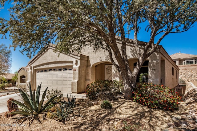 5354 W Eagle Claws Ct, Marana, AZ 85658 - view of front of home featuring concrete driveway, a garage, and stucco siding