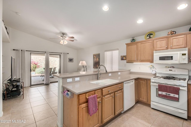 5354 W Eagle Claws Ct, Marana, AZ 85658 - kitchen with a healthy amount of sunlight, white appliances, a sink, a peninsula, and lofted ceiling