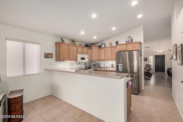 5354 W Eagle Claws Ct, Marana, AZ 85658 - kitchen featuring range with gas stovetop, light tile patterned floors, white microwave, and stainless steel fridge