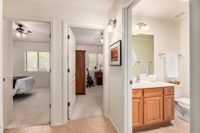5354 W Eagle Claws Ct, Marana, AZ 85658 - bathroom with visible vents, ceiling fan, vanity, and ensuite bath