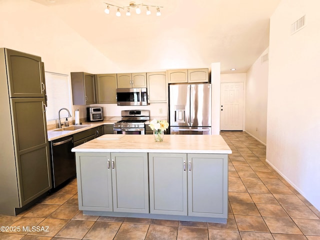 kitchen with visible vents, stainless steel appliances, light countertops, and a sink