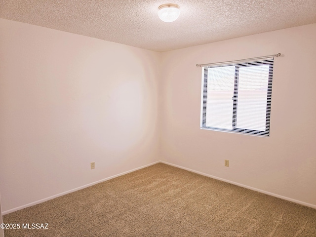 unfurnished room with carpet floors, a textured ceiling, and baseboards