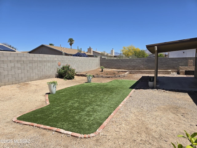 view of yard with a fenced backyard and a patio