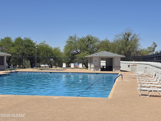 pool featuring fence and a patio area