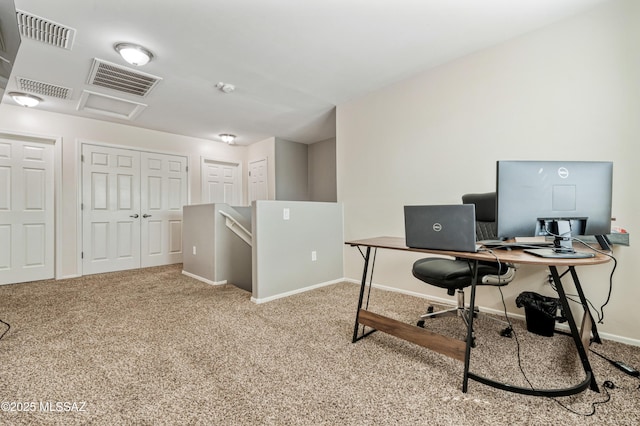 carpeted office space featuring attic access, baseboards, and visible vents