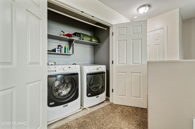 clothes washing area featuring washer and dryer and laundry area