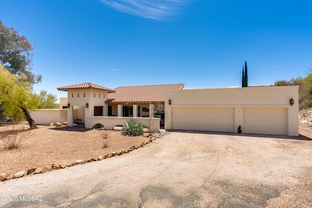 4644 N Avenida Del Cazador, Tucson, AZ 85718 - view of front facade featuring driveway, an attached garage, stucco siding, and a tile roof