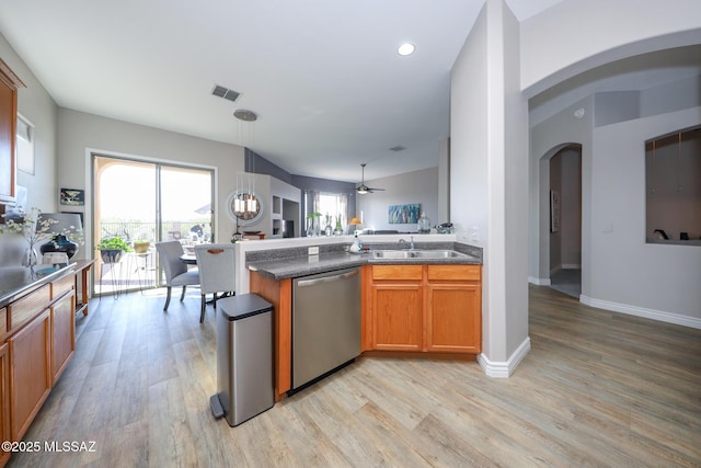 kitchen with visible vents, arched walkways, dishwasher, and light wood-type flooring