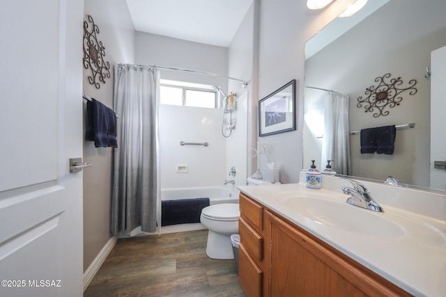 full bath featuring toilet, wood finished floors, shower / bath combo, and vanity